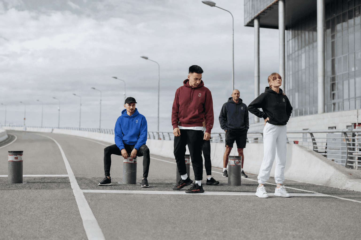 Group of friends wearing Zieck hoodies on a Groningen bridge