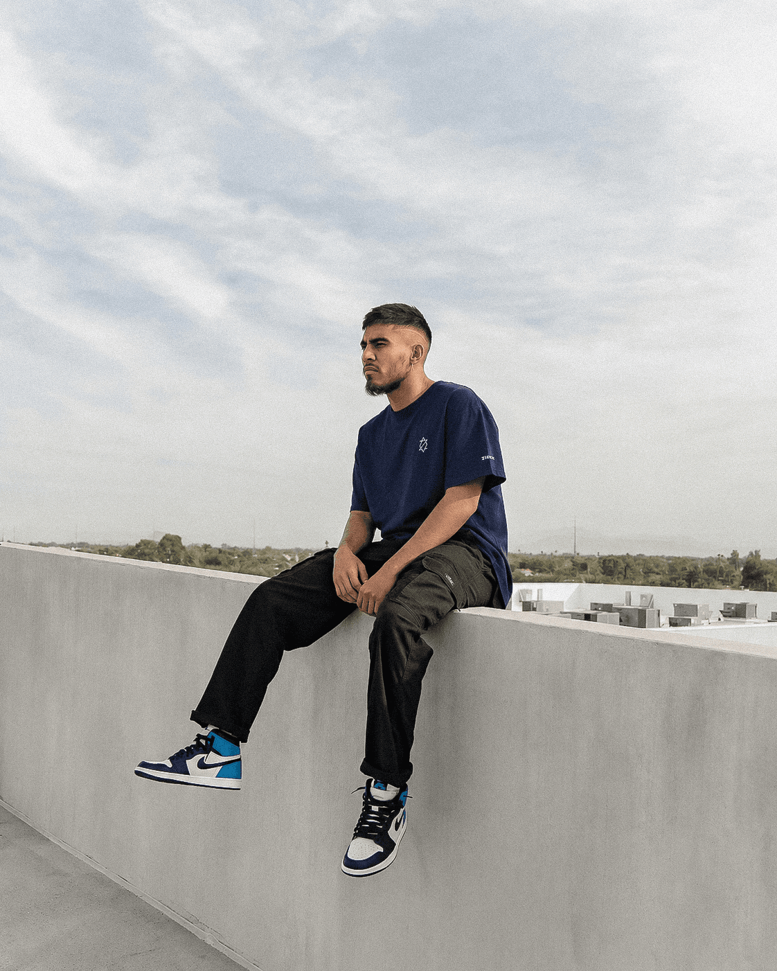 Man wearing a Zieck tee on a rooftop